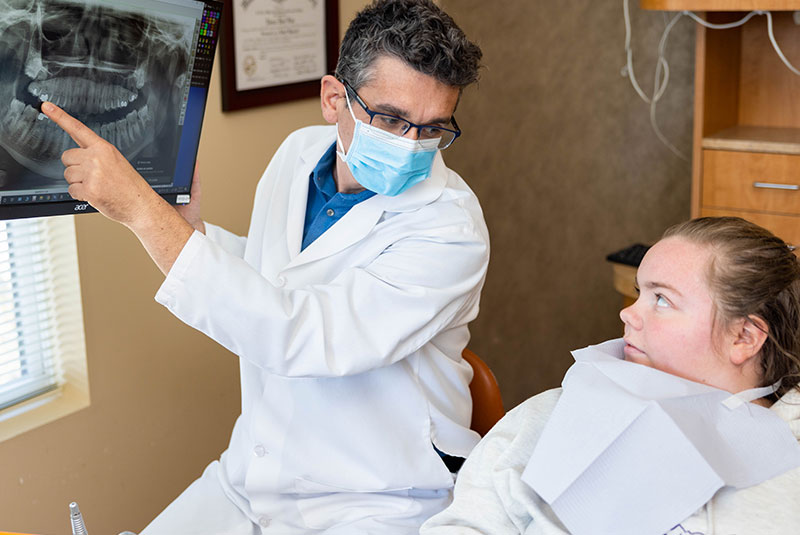 Dr. Catalin Constantin showing patient display of his mouth x-ray