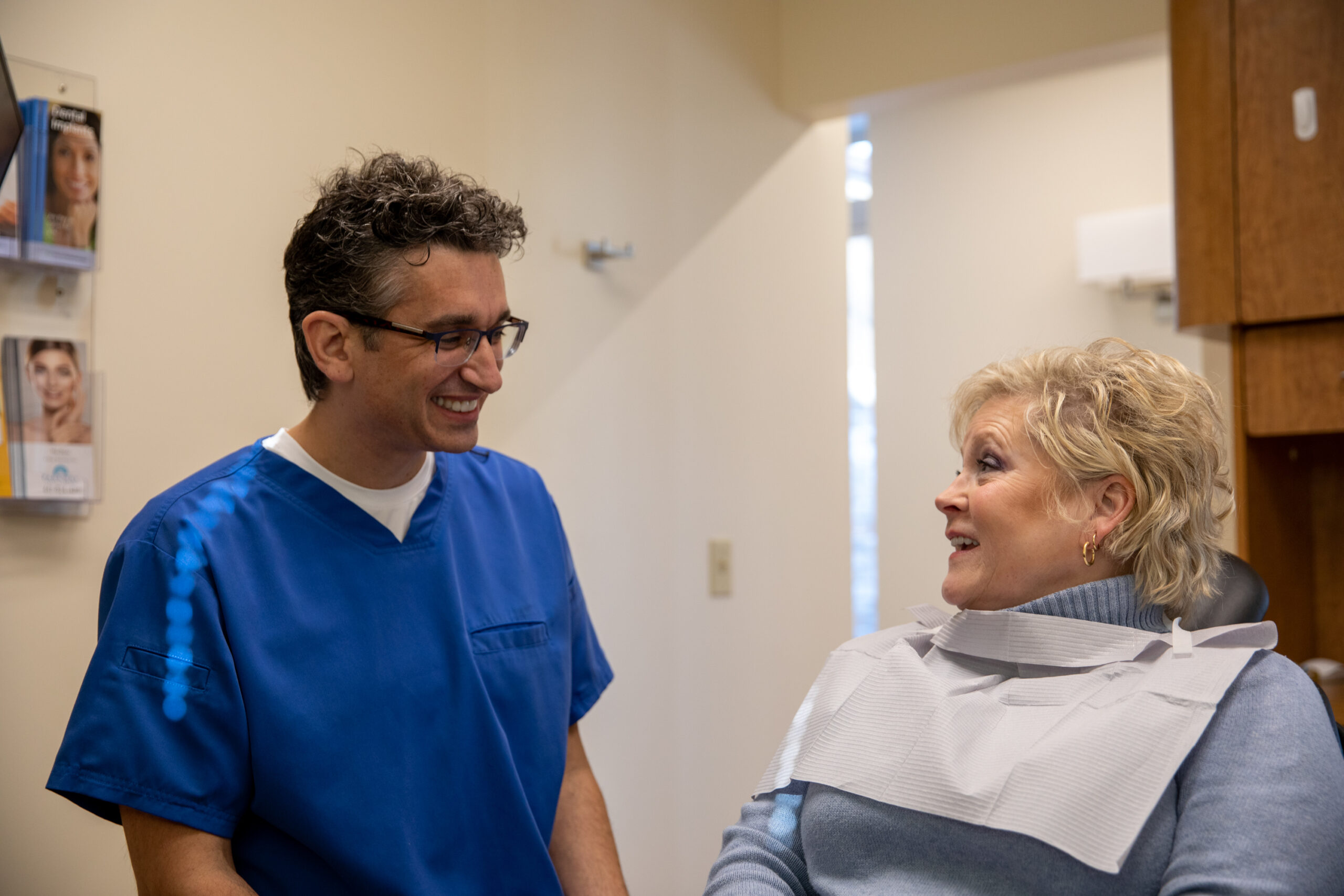 Dr. Constantin talking to a patient about her All-On-X dental implant procedure.