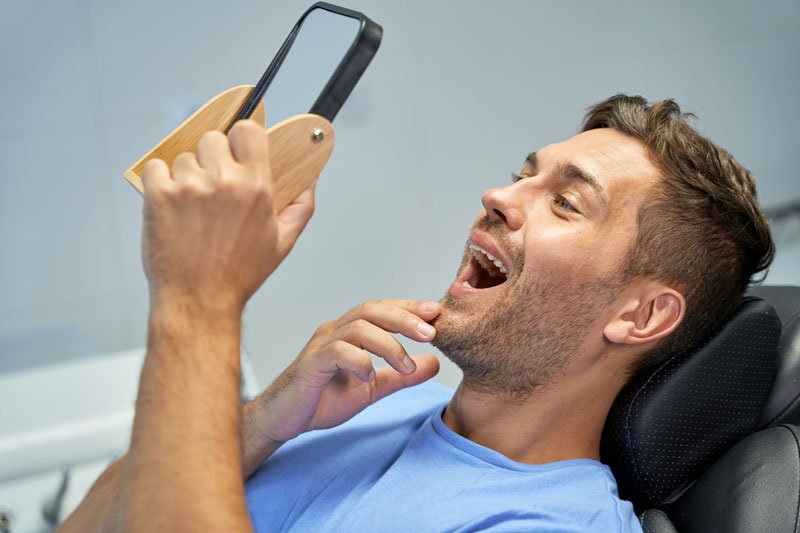 guy looking at smile through mirror