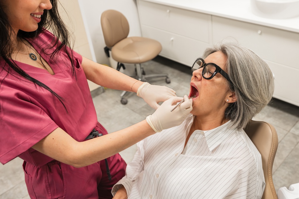 A diverse group of people smiling, showcasing different replacing teeth options. Include examples of dental implants, bridges, and dentures. No text on the image.
