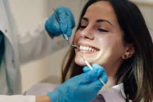 Dentist explaining Invisalign treatment to a patient in a modern dental office
