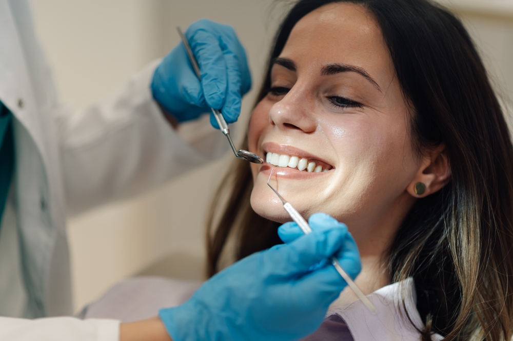 Dentist explaining Invisalign treatment to a patient in a modern dental office
