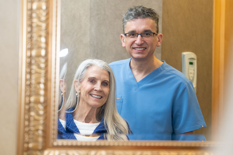doctor c with patient for smile reveal mirror